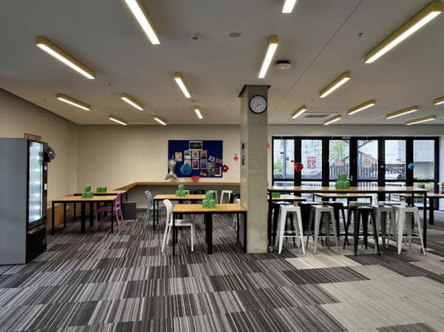 Tables chairs vending machine communal area at UniLodge Auckland City in Auckland Student Accommodation
