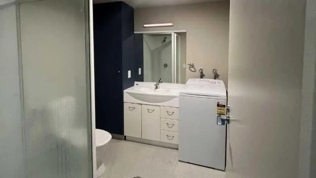 Sink cabinets shower and washing machine bathroom at UniLodge Stafford House in Wellington Student Accommodation