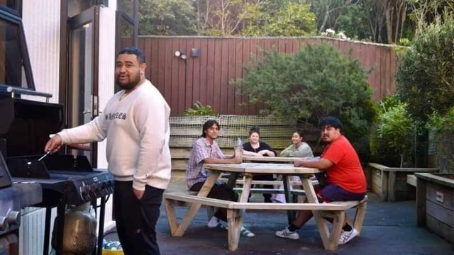 People gather around picnic table and grill exterior at UniLodge Stafford House in Wellington Student Accommodation