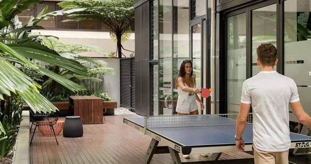 Table tennis players in outdoor communal area playing area at Iglu Brisbane City in Brisbane Student Accommodation