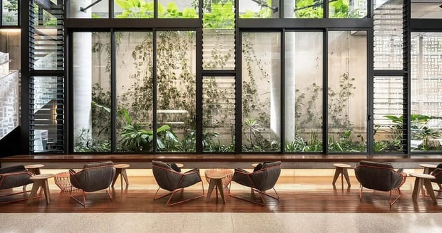 Modern lounge area with chairs tables and greenery living room at Iglu Brisbane City in Brisbane Student Accommodation