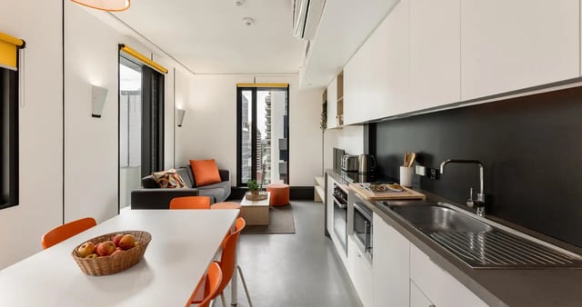Sofa table and kitchen area combined living room kitchen at Iglu Brisbane City in Brisbane Student Accommodation