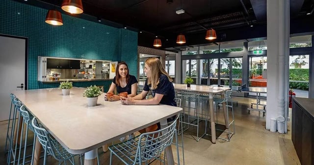 Two students at large table common area at Iglu Kelvin Grove in Brisbane Student Accommodation