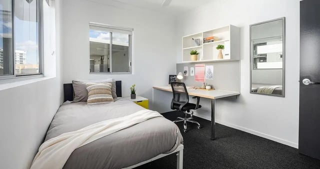 Bed desk chair shelving mirror bedroom at Iglu Kelvin Grove in Brisbane Student Accommodation