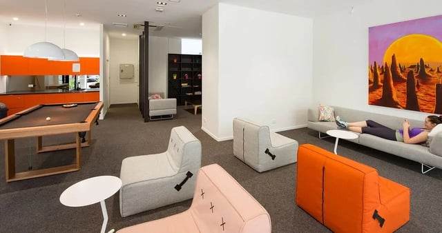 Pool table orange kitchen lounge living area at Iglu Kelvin Grove in Brisbane Student Accommodation