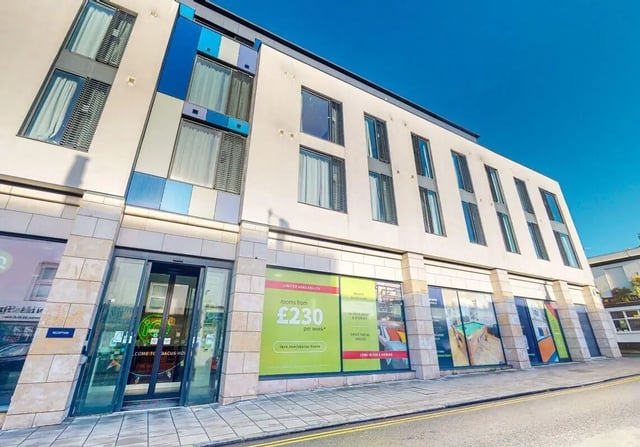 Modern building entrance with blue accents exterior at iQ Abacus House in Brighton Student Accommodation