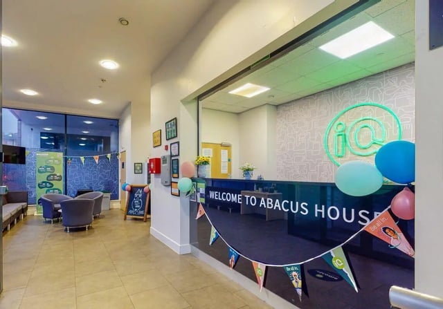 Reception desk with seating and balloons reception area at iQ Abacus House in Brighton Student Accommodation
