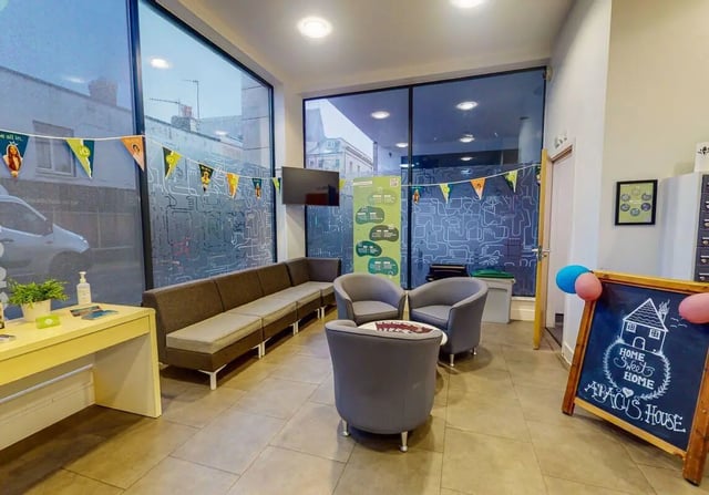 Sofa chairs TV desk and blackboard common area at iQ Abacus House in Brighton Student Accommodation