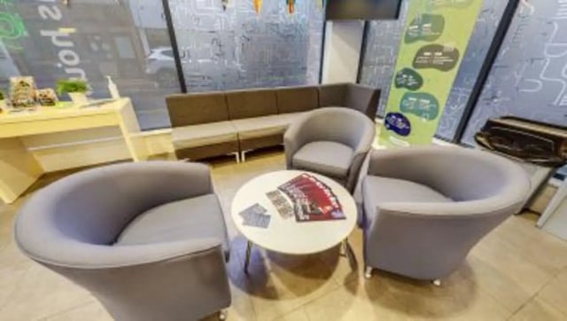 Gray lounge chairs round table brochures reception area at iQ Abacus House in Brighton Student Accommodation