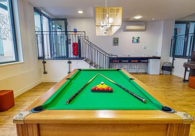 Pool table with cues and balls playing area at iQ Abacus House in Brighton Student Accommodation