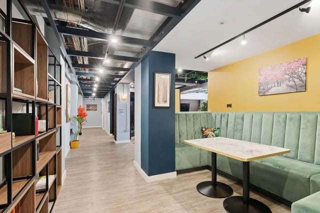 Green booth table with art living room at Pennine House in Leeds Student Accommodation