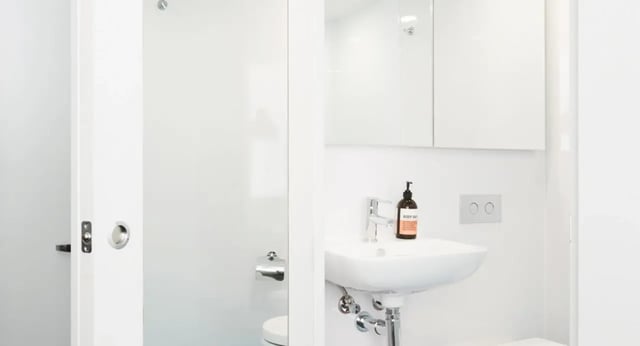 White sink soap dispenser flush plate toilet Bathroom at Scape South Bank in Brisbane Student Accommodation