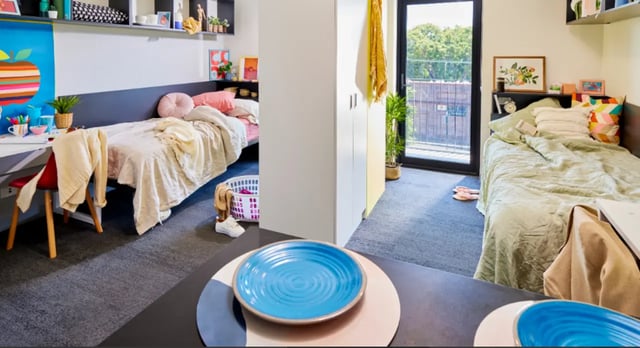 Two beds desk and balcony student accommodation bedroom at Scape Glebe in Sydney Student Accommodation
