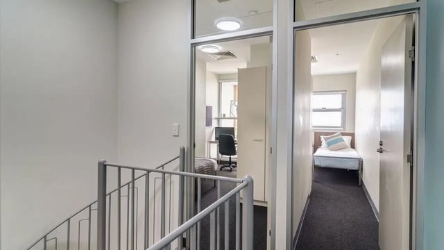 Hallway with beds and desk student accommodation interior at UniLodge @ Metro Adelaide in Adelaide Student Accommodation