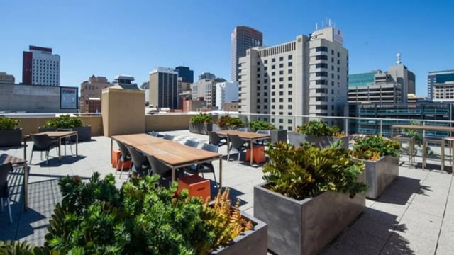 Rooftop dining tables with city skyline exterior at UniLodge @ Metro Adelaide in Adelaide Student Accommodation
