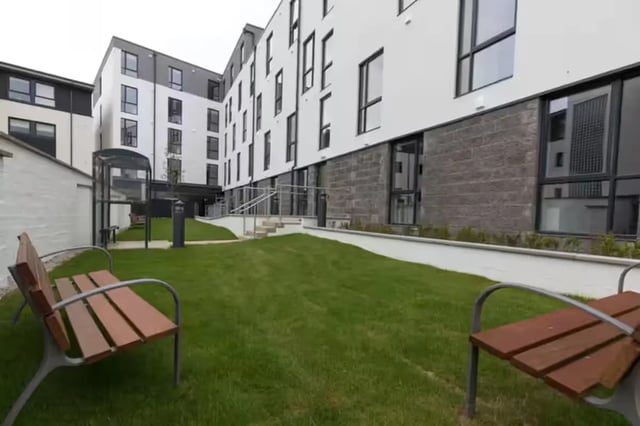 Benches grass building exterior and entrance at St Peter Studios in Aberdeen Student Accommodation
