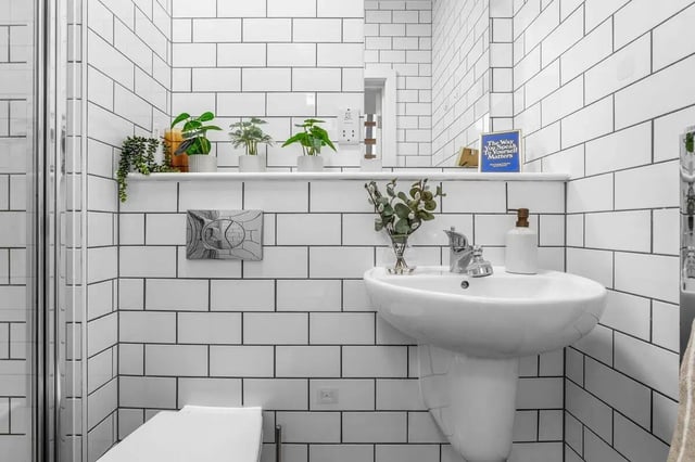 Sink plants soap dispenser and toilet bathroom at Algernon Firth in Leeds Student Accommodation
