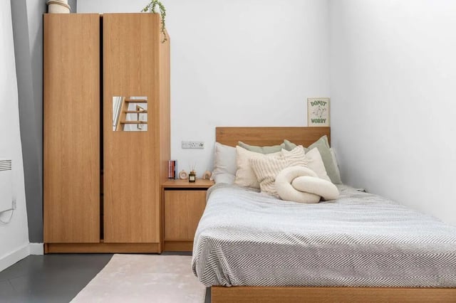 Wooden wardrobe bed side table bedding bedroom at Algernon Firth in Leeds Student Accommodation