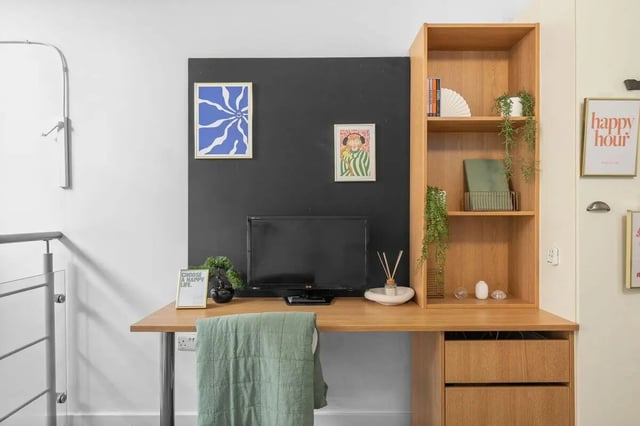 Desk with monitor plants and shelves study area at Algernon Firth in Leeds Student Accommodation