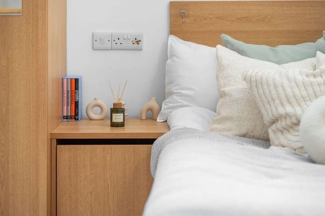 Bedside table with books diffuser and pillows Bedroom at Algernon Firth in Leeds Student Accommodation