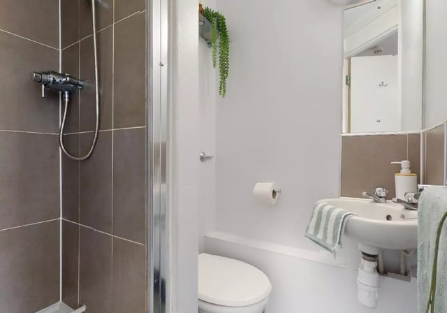 Shower toilet sink and towel bathroom at iQ Lambert & Fairfield House in Manchester Student Accommodation