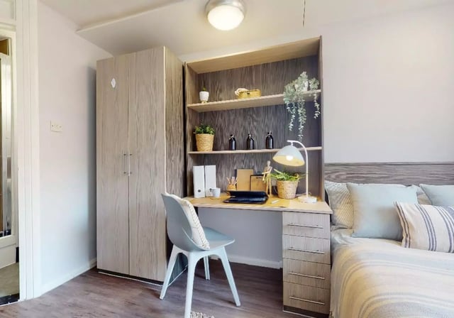 Desk lamp shelves chair and bed Bedroom at iQ Lambert & Fairfield House in Manchester Student Accommodation