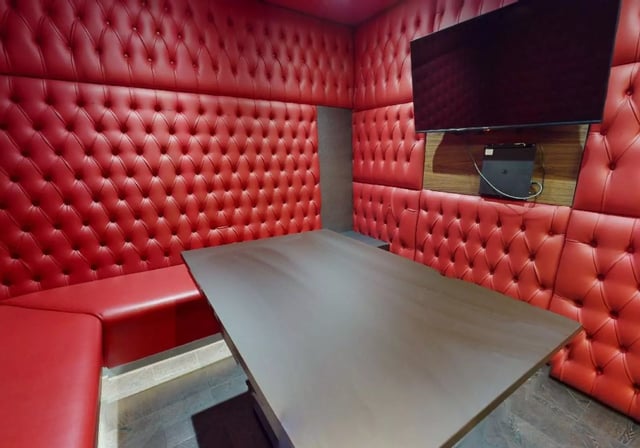 Red tufted seating and table gaming area at iQ Lambert & Fairfield House in Manchester Student Accommodation