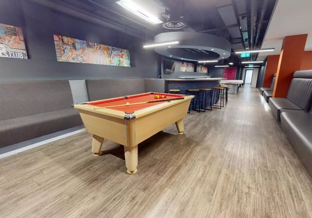 Pool table long bench bar stools living area at iQ Lambert & Fairfield House in Manchester Student Accommodation