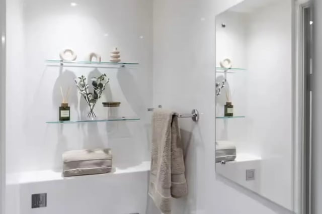 Shelves with decor diffuser towel rack bathroom at Portobello House in Sheffield Student Accommodation