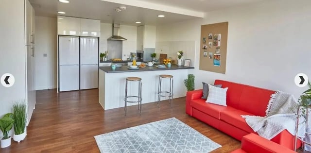 Kitchen island with stools red sofa living room at Grenville Street in Liverpool Student Accommodation