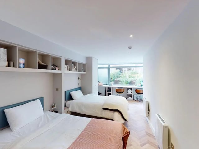 Two beds study area and shelving Bedroom at Arasain P&V in Dublin Student Accommodation
