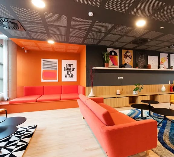 Orange sofas artwork modern shelving living room at Brickworks in Dublin Student Accommodation