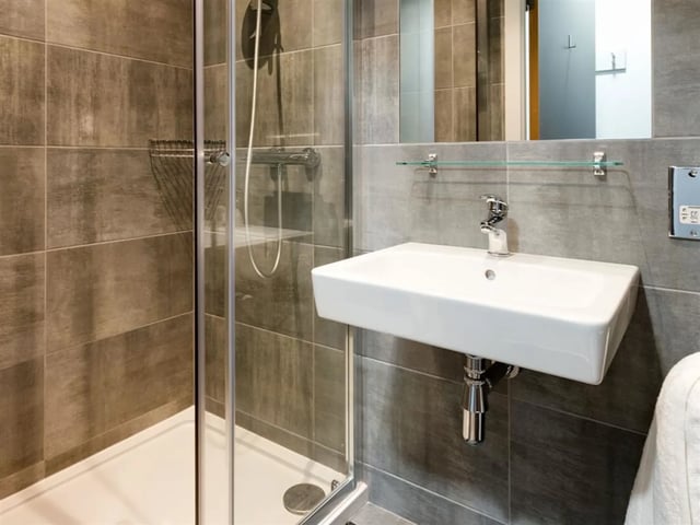 Sink shower and tiled walls bathroom at Brickworks in Dublin Student Accommodation