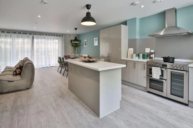 Sofa island kitchen cabinets oven and stove kitchen at Ocean View in Falmouth Student Accommodation