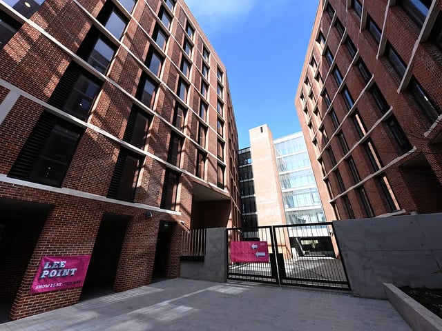 Brick buildings with many windows and signs exterior at Lee Point in Cork Student Accommodation
