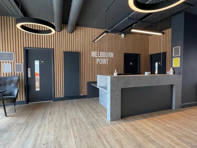 Reception desk doors wooden wall and floor reception area at Melbourn Point in Cork Student Accommodation