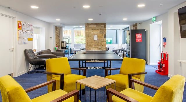 Ping pong table yellow chairs common room at Goods Corner in Edinburgh Student Accommodation