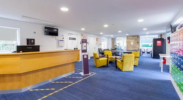 Reception desk yellow chairs lounge area living room at Goods Corner in Edinburgh Student Accommodation