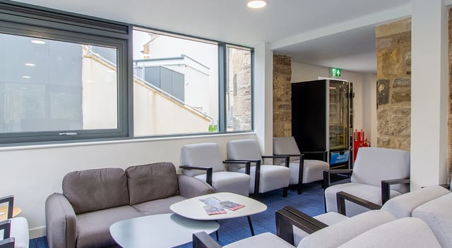 Sofa chairs tables and vending machine lounge at Goods Corner in Edinburgh Student Accommodation