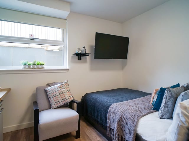 Armchair bed TV small plants bedroom at Goods Corner in Edinburgh Student Accommodation