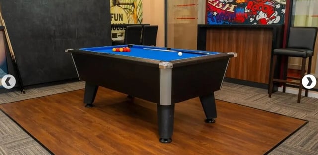 Pool table with balls cue sticks and bar stools Playing area at Marybone Student Village 3 in Liverpool Student Accommodation