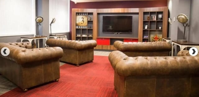 Brown leather sofas and TV unit living room at Marybone Student Village 3 in Liverpool Student Accommodation