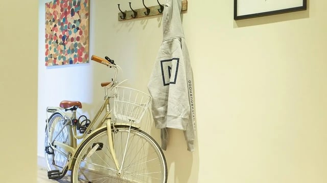 Bicycle and gray hoodie hanging entry area at Canvas The Parade in Cardiff Student Accommodation