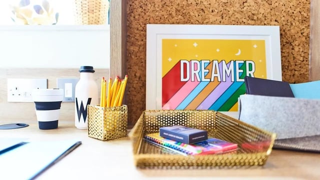 Desk with pencils cup artwork and stationery study area at Canvas The Parade in Cardiff Student Accommodation