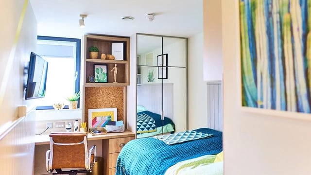 Desk chair television shelves mirror bed Bedroom at Canvas The Parade in Cardiff Student Accommodation