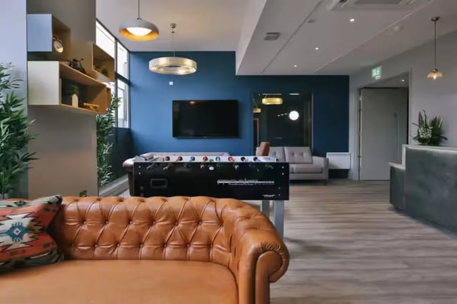 Foosball table couch television sofa living area at Metrovick House in Newcastle Upon Tyne Student Accommodation