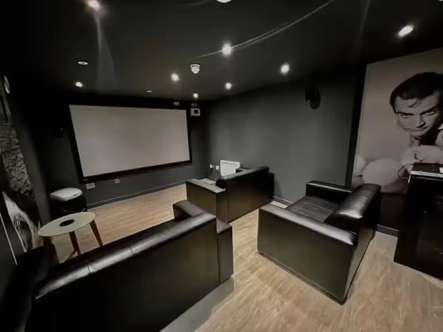 Sofas projector screen large movie poster cinema room at Metrovick House in Newcastle Upon Tyne Student Accommodation