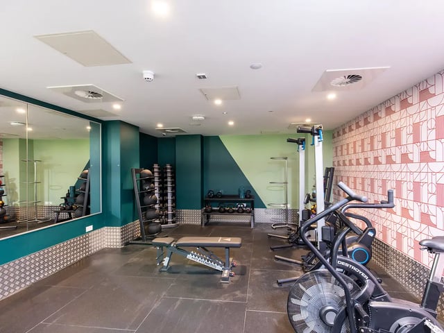 Gym with weights bench and exercise machines gym at Brewers Close in Dublin Student Accommodation