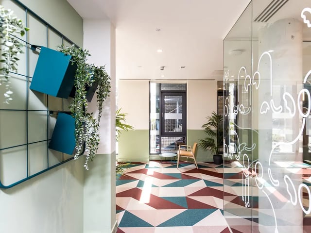 Geometric floor teal planters hanging plants chair common area at Brewers Close in Dublin Student Accommodation
