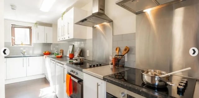 White kitchen cabinets sink stovetop and appliances kitchen at Coopers Court in London Student Accommodation